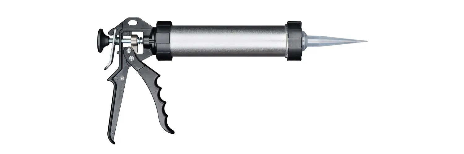 Black metal enclosed sausage applicator gun with silver barrel and clear nozzle