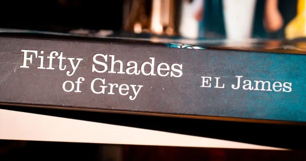 Close-up, angled shot of the spine of the book "Fifty Shades of Grey" by E.L. James.