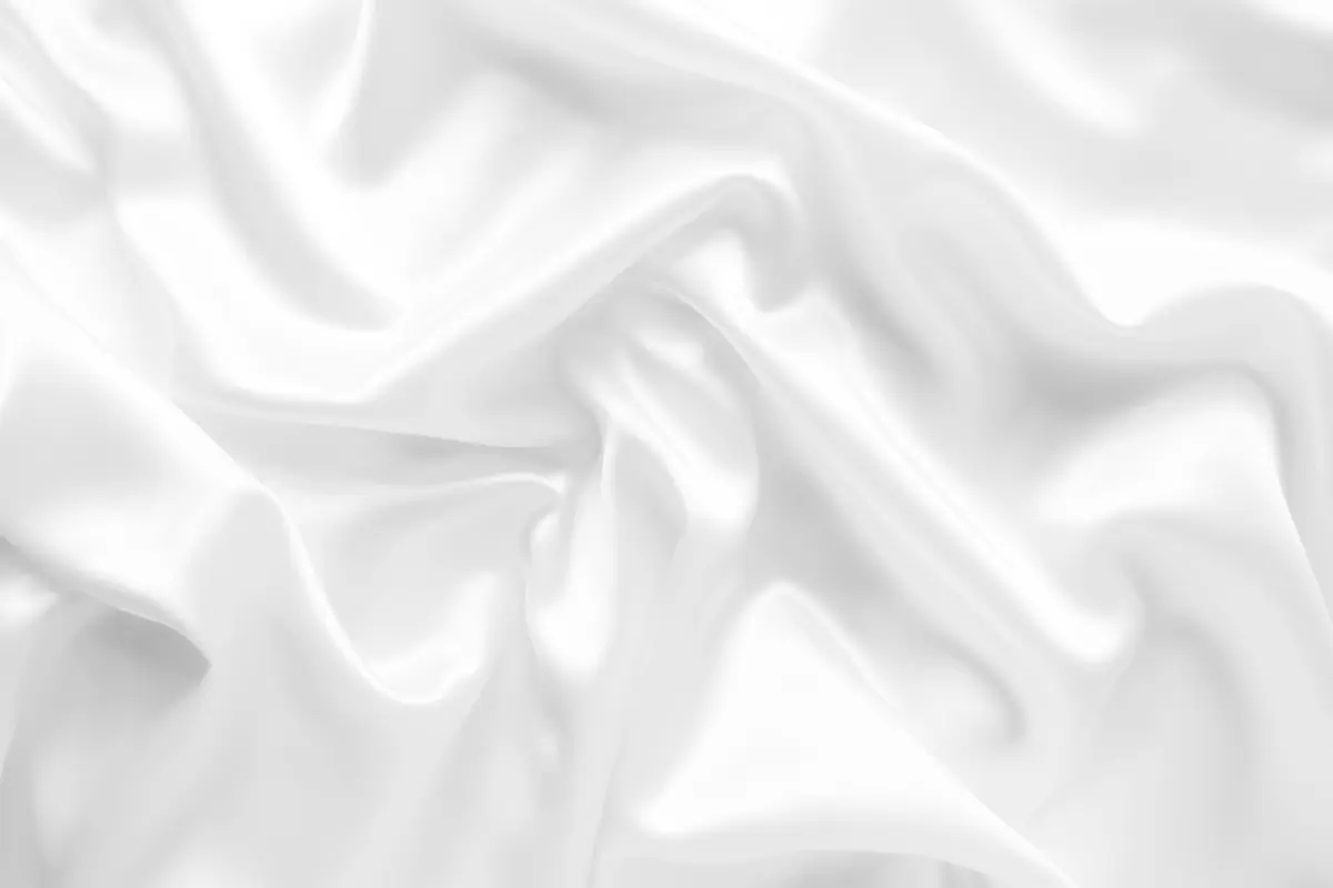 Luxuriously smooth white material gathered into wavy bundles to communicate the different shades of grey and white sealant